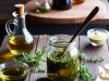 Stop Buying These 10 Things: Easy DIY Alternatives That Save You Money. 💰✨ Homemade salad dressing in a mason jar with fresh ingredients like olive oil and herbs.