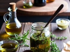 Stop Buying These 10 Things: Easy DIY Alternatives That Save You Money. 💰✨ Homemade salad dressing in a mason jar with fresh ingredients like olive oil and herbs.