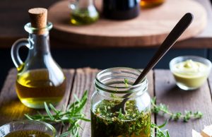 Stop Buying These 10 Things: Easy DIY Alternatives That Save You Money. 💰✨ Homemade salad dressing in a mason jar with fresh ingredients like olive oil and herbs.