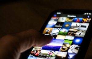 10 Hidden iPhone Features That Will Make You Feel Like a Tech Genius A finger selecting multiple iPhone photos at once by dragging diagonally across the screen.