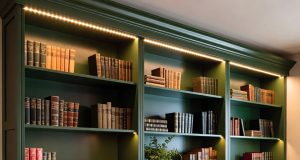 IKEA Hacks: 7 Genius Ways to Transform Your Billy Bookcase A floor-to-ceiling built-in bookcase made from multiple IKEA Billy units, painted a deep emerald green with classic white crown molding.