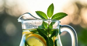 Hydration Hacks: Fun Ways to Drink More Water A refreshing pitcher of fruit and herb-infused spa water with lemon, cucumber, and mint.